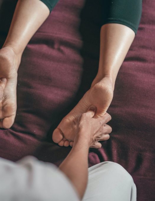 Hands of Registered Massage Therapist on the back of their client